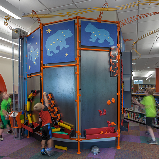 children playing with magnetic wall exhibits